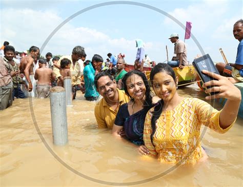 image of indian hindu girl devotees taking holy bath in river krishna during pushkaralu qx157141