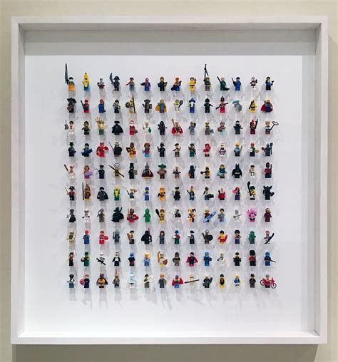 A Treasured Collection Of Lego Minifigures Framed In A White Box Frame