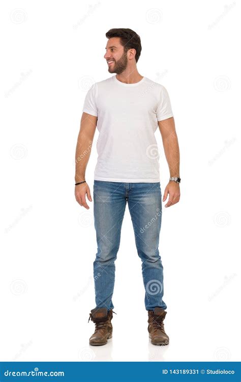 Smiling Man In Jeans And White T Shirt Is Standing And Looking Away Front View Stock Image
