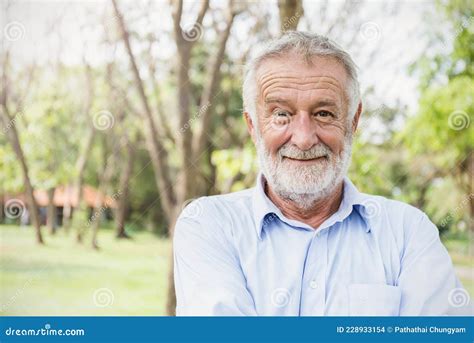 Portrait Of Healthy Happy Smile Senior Elderly Caucasian Old Man In The Park Outdoors With Copy