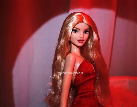 a barbie doll with long blonde hair in a red dress