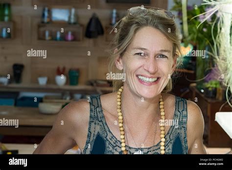 Portrait Of French Blonde Mature Woman Smiling In Her Handmade Ts Store In France