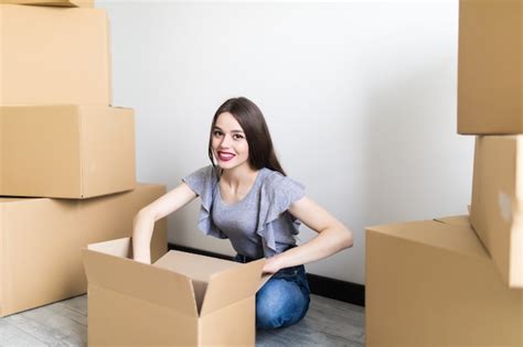 Free Photo Smiling Satisfied Young Woman Customer Sit On Sofa Unpack