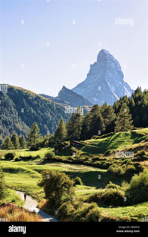 Matterhorn Mountain And Green Valley With Traditional Swiss Chalet In
