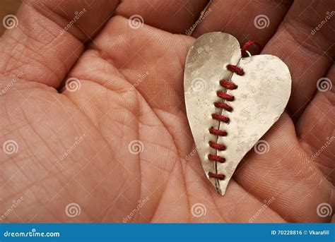 Broken Heart Stitched with Red Thread on a Hand Stock Photo - Image of
