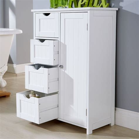 A White Cabinet With Drawers And Letters On The Top Shelf Next To A Bathtub