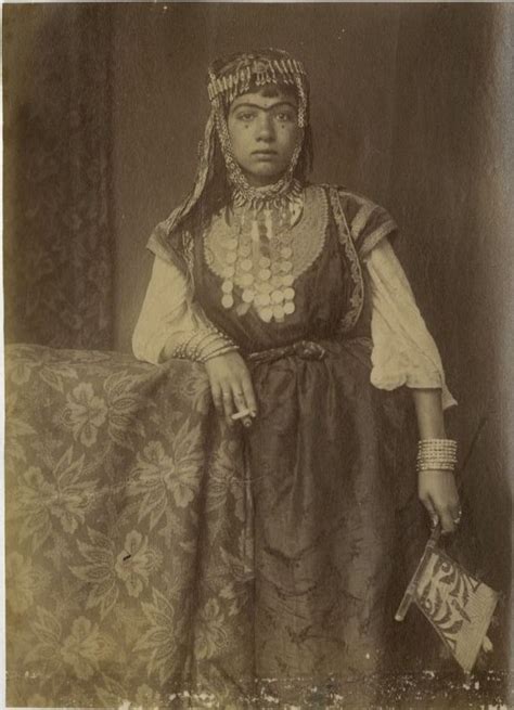 An Old Black And White Photo Of A Woman In Traditional Dress With