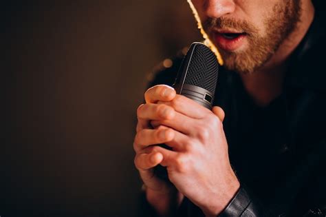 Free Photo Singer With Microphone Singing In Studio
