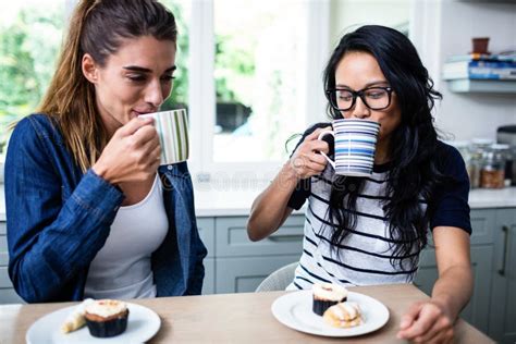 Young Female Friends Drinking Coffee At Table Stock Image Image Of