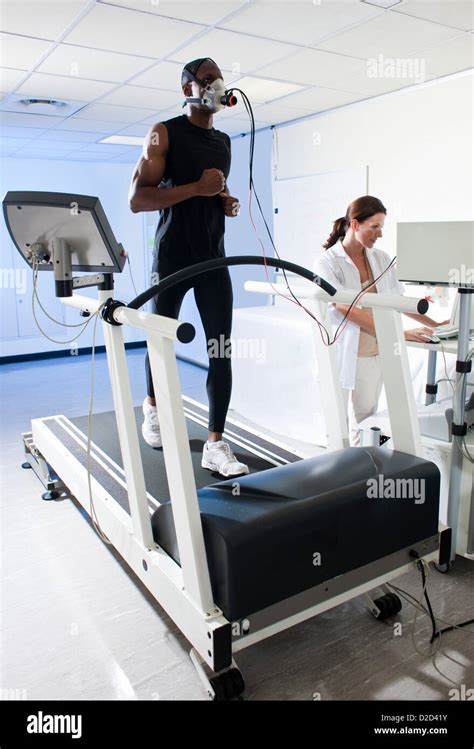 Model Released Performance Testing Athlete Running On A Treadmill While His Performance And