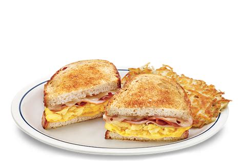 Lelow plustard and swiss cheese. Grilled sourdough bread stuffed with ham, scrambled eggs ...