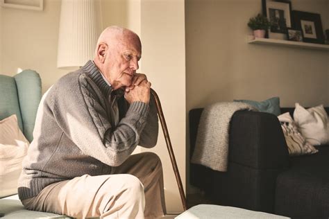 Elderly Man Sitting Alone At Home Rehab First