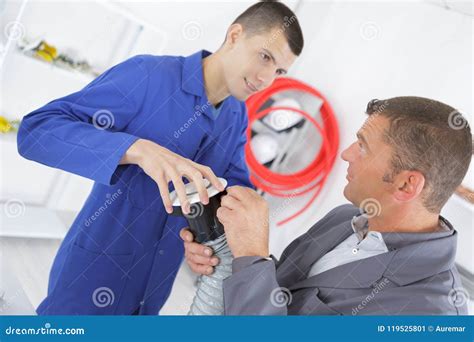 Ac Technician Apprentice With Instructor In Building Stock Image