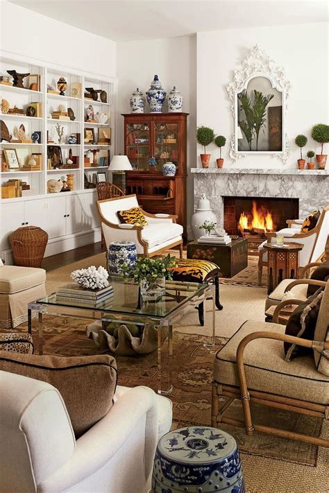 A Living Room Filled With Furniture And A Fire Place In The Middle Of