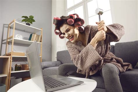 Woedende Vrouw In Haarrollers Die Haar Laptop Vernietigt Met Een Hamer Stock Afbeelding Image