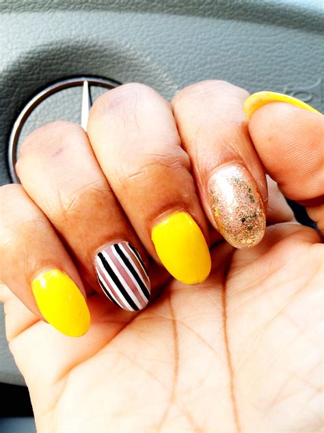 Spice your look with a manicure that makes you feel like you are part of the royal family. #OnTheRun concert nails. Neon Yellow with gold glitter accent nail and black and white stripes ...