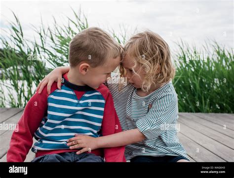 Happy Siblings Hugging Other Fotos Und Bildmaterial In Hoher Auflösung Alamy
