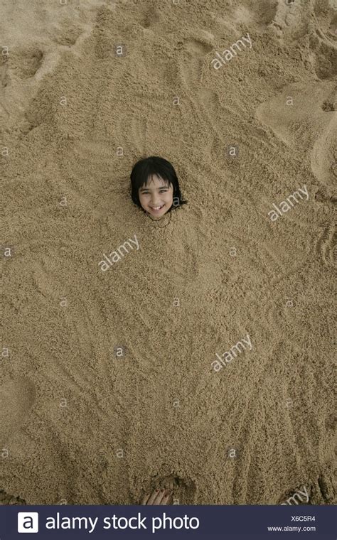 Girl Buried In Sand High Resolution Stock Photography And Images Alamy