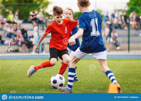 Boys Play Soccer Game Junior Competition Between Players Running And