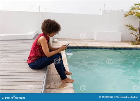 Woman Using Mobile Phone Near Swimming Pool at Home Stock Image - Image