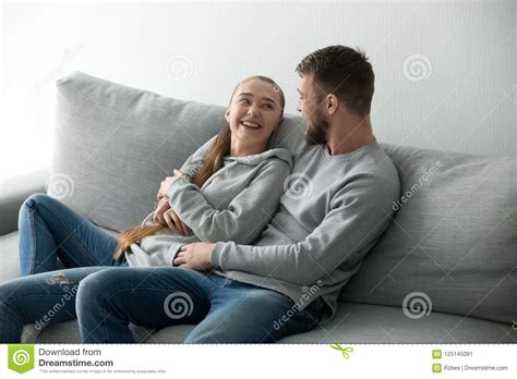 Smiling Couple Hugging Relaxing At Cozy Sofa Stock Image Image Of