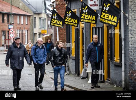 BAARLE-NASSAU - People with boxes of fireworks in the streets of the