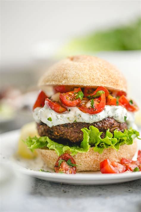 juicy and tender grilled lamb burgers topped with a fresh flavored greek yogurt sauce and a