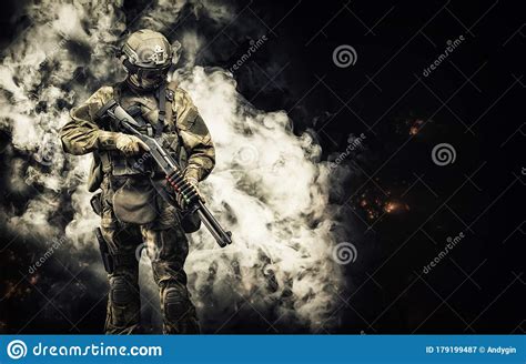 american soldier comes out of the smoke on the battlefield the concept of military special