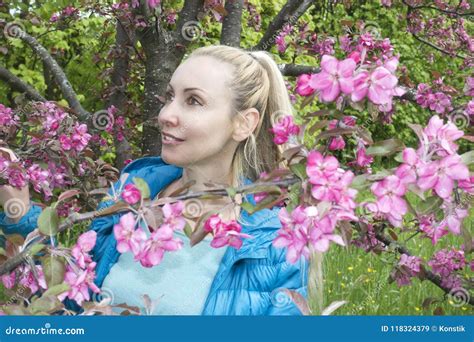 Young Attractive Woman Standing Near The Blossoming Crimson Apple Tree Stock Image Image Of