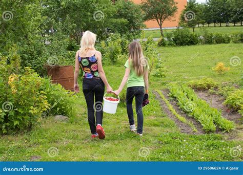 Mother And Daughter Walk Home From The Garden Stock Images Image 29606624