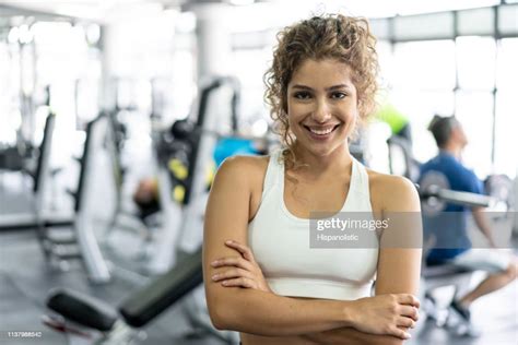 Confident Young Female Personal Trainer At The Gym Smiling At Camera