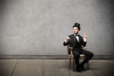Young Elegant Man Sitting On A Chair Stock Photo Image Of Fashion