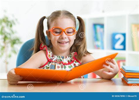 Happy Funny Child Girl In Glasses Reading A Book Stock Photo Image Of