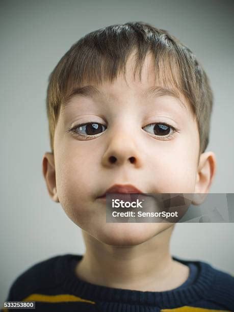 Portrait Of A 4 Years Old Boy With Bored Expression Stock Photo