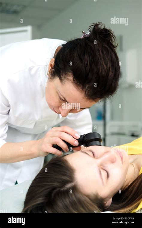 Female Dermatologist Using A Professional Dermatoscope While Doing Skin