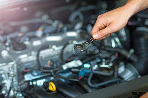 Mechanic Working On Car Engine In Auto Repair Shop Stock Photo Image
