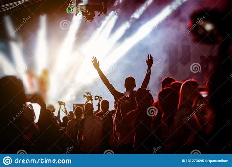 Happy People Enjoying Rock Concert Raised Up Hands And Clapping Of