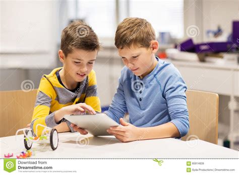 Kids With Tablet Pc Programming At Robotics School Stock