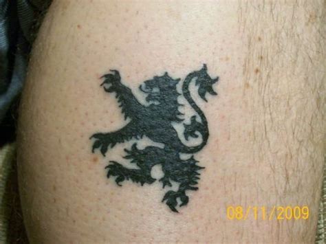 A Man With A Tattoo On His Leg That Has A Lion On The Front Of It