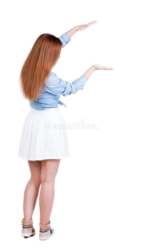 Back View Of Beautiful Woman In Dress Looking At Wall And Holds Stock