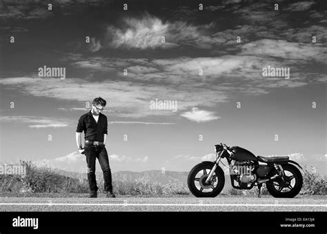 Black And White Portrait Of Mid Adult Male Motorcyclist On Highway