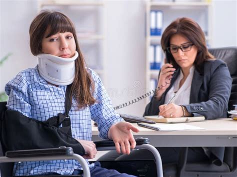Injured Employee Visiting Lawyer For Advice On Insurance Stock Photo
