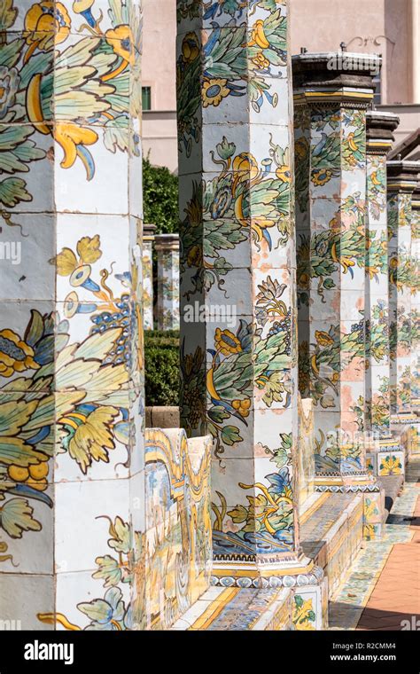 colorful tiled pillars and bench in the cloister garden at the santa chiara monastery in via
