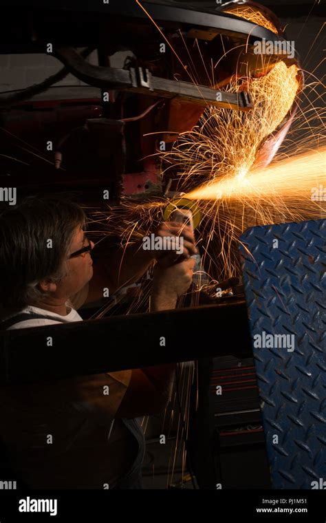 Male Mechanic Using Grinder Machine Stock Photo Alamy