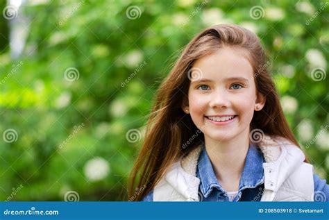 Portrait Of Adorable Smiling Little Girl Child Pre Teen In The Park