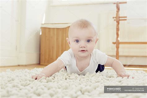 Portrait Of Smiling Baby Boy Crawling On Rug — Front View Wearing