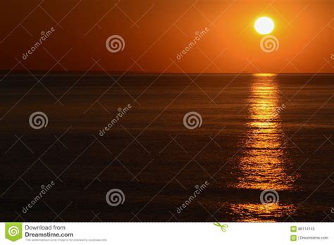 The Sunrise From The Sea With The Sun On Right Orange Sky And Long