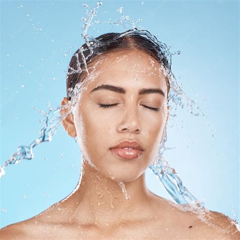Premium Photo Woman Washing Face Or Water Splash Skincare On Blue