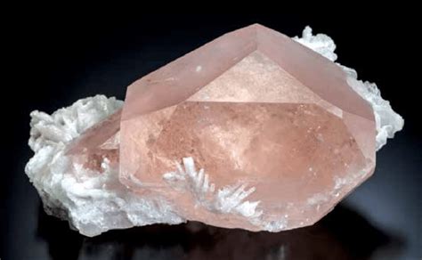 A Pink Rock With White Crystals On It