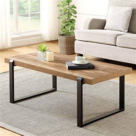 This coffee table enhances your living room with its streamlined silhouette and extensive shelf space. FOLUBAN Rustic Coffee Table,Wood and Metal Industrial Cocktail Table for Living Room, 47 Inch ...